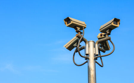 Four ways, CCTV on Post with plain sky background.