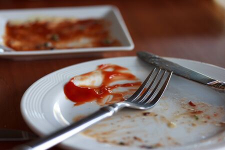 Plate with remaining of tomato source after complete take of steak, so delicius.の写真素材