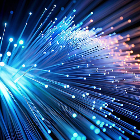Close-up of illuminated fiber optic strands, showcasing their vibrant blue, white, and orange glow against a dark background.の素材