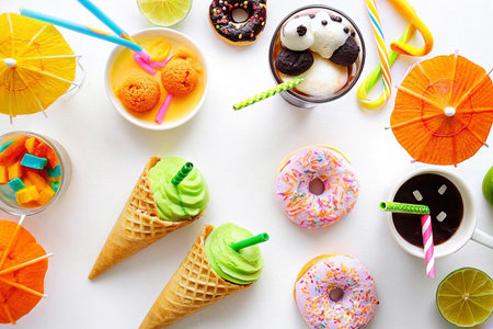 Colorful summer treats ice cream, donuts, and drinks.の素材