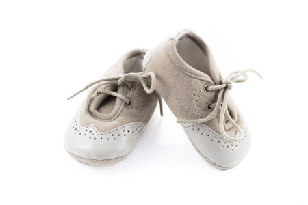 Beige shoes for kids isolated on a white backgroundの写真素材