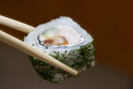roll with chicken and dill taken with sticksの写真素材