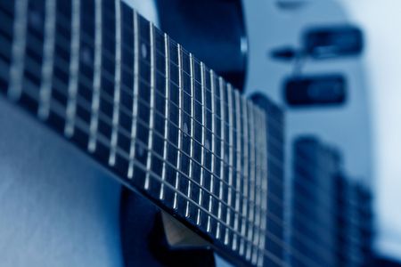 black 8th string guitar isolated toned blueの写真素材