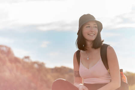pretty young hispanic latin white girl in pink with hat and black pants posing standing smiling with...