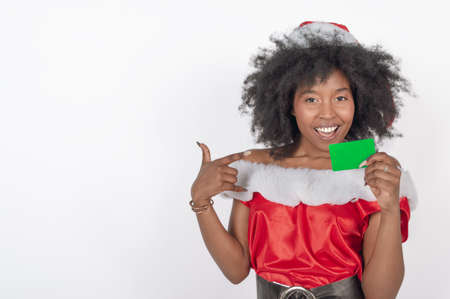 happy young woman giving a christmas present in a red costume, white copy spaceの写真素材