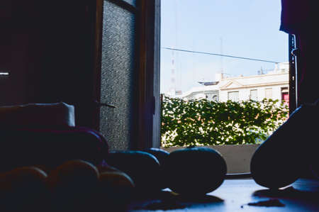 vegetables on a table in the dark with the door open and the sky in the background