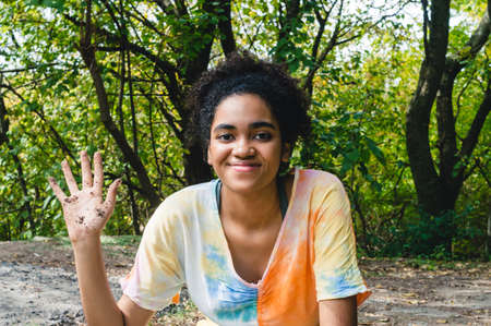 portrait young brunette worker woman with afro worker in the field smiling looking at the camera...