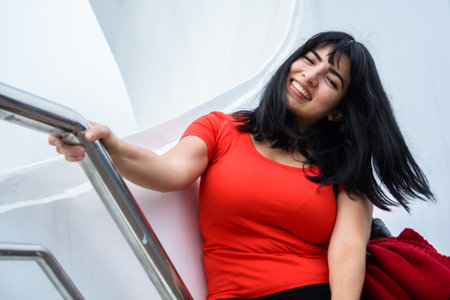 closeup portrait of young latin woman tourist of venezuelan ethnicity, sitting on Puente De La Mujer in Buenos Aires, smiling enjoying vacation day,の写真素材