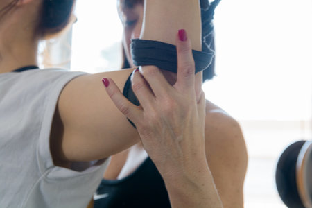 close-up of hand of caucasian female exercise and rehabilitation instructor, sitting touching her...