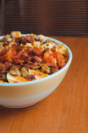vertical image for website and social networks of restaurants, of salad with egg, bacon and...
