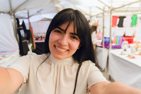 Portrait of young Latin traveler woman with long black hair and white clothes, on vacation taking...