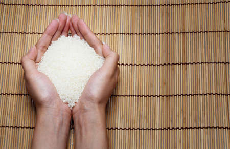 japanese rice in your hand on Japanese mats の写真素材