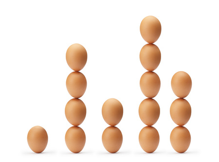 Stacked eggs in the shape of a graph, isolated on a white background