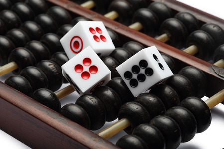 three dice on abacus are symbolic of gambling