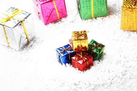 The small gift box group on snow for decoration christmasの写真素材