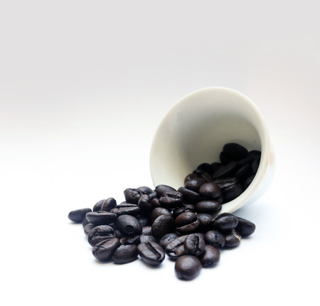 Close up coffee bean in cup isolated on white backgroundの写真素材