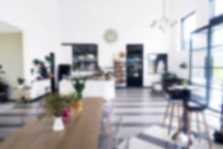 Wood dinning table in clean modern design restaurant interior - Blur image use for background.の写真素材