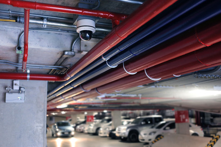 CCTV security camera surveillance system installed on city building or parking lots. Equipment for...