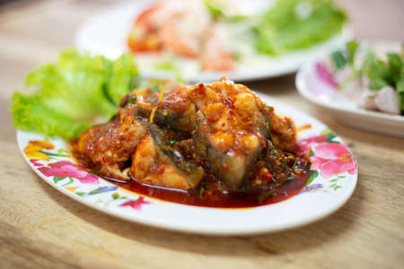 Stir-fried deep fried fish (Asian redtail catfish) with red curry paste. Thai healthy asian food from fish cooked.の写真素材