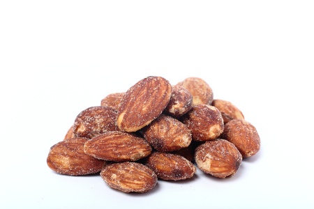 salted and roasted almonds on white background の写真素材