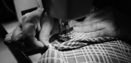 Sewing process with sewing machine. (Selective focus, black and white picture)の写真素材