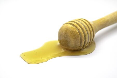 Honey dripping isolated on white background.の写真素材