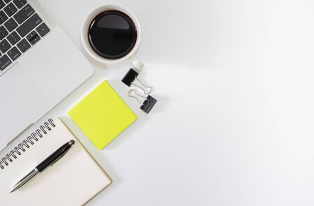 Flat lay, of white office desk with laptop, empty notebook, pen, black coffee cup and other office supplies. with copy space,の写真素材