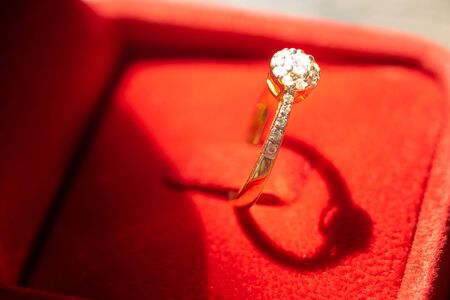 Close up of Gold wedding ring or engagement ring in red box. Ring beautiful and elegant. Gift for marry or celebrate. Love and Wedding concept with copy space.の写真素材