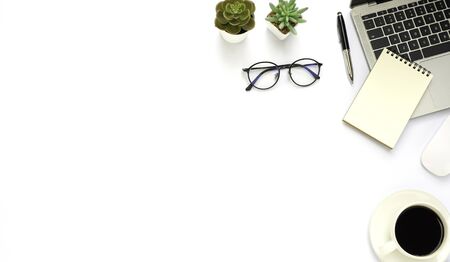 Workspace in office with white table. Top view from above of laptop with notepad and coffee. Desk for modern creative work of designer. Flat lay with blank copy space. Business and finance concept.の写真素材