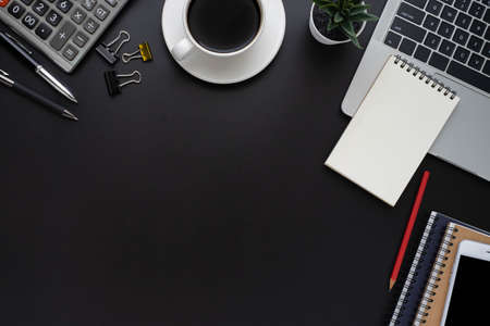 Black office desk table with laptop, notebook and coffee cup with equipment other office supplies. Business and finance concept. Workplace, Flat lay with blank copy space, Top view.の写真素材