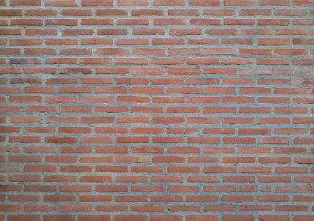 Red brick-cement wall grunge background. Old dark stone, vignette texture, Abstract surface brown rough brick wall pattern. Vintage concrete, cement brickwork. Blank copy space for design backdrop.の写真素材