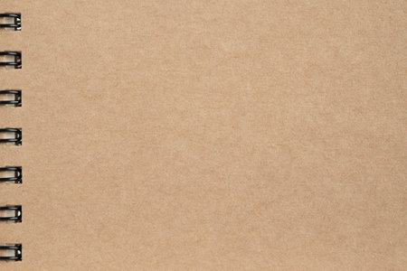 Blank, brown spiral notebook cardboard sheet. Paper craft abstract background.  Retro, old vintage...