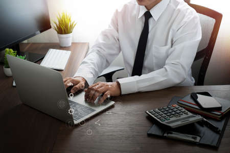 Digital marketing technology on network communication. Businessman hands working with laptop...