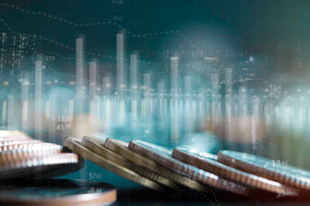 Double exposure of city and stack rows money coin with trading graph chart stock market. Value exchange and marketing of bank fund economic profit with growth. Finance investment and business concept.の写真素材