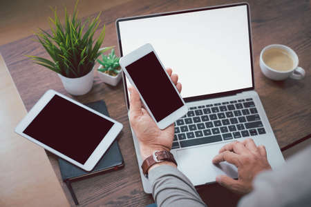 Shot of man hand using, holding smartphone or mobile mockup with blank black screen display. Phone technology, digital modern design can use touch screen with copy space.の写真素材