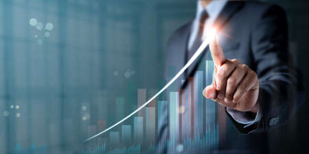 Businessman hand touching point arrow graph economic growth success chart. Analysis strategy data digital communication online connection. Business finance technology and marketing concept.の写真素材
