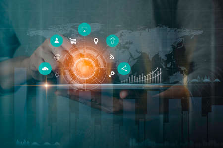 Businessman holding tablet with showing a growing hologram stock, analyzing sales data and economic growth plan graph chart success. Business finance and marketing digital technology concept.の写真素材