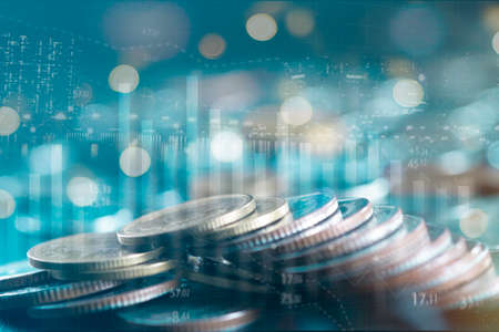 Double exposure of city and stack rows money coin with trading graph chart stock market. Value exchange and marketing of bank fund economic profit with growth. Finance investment and business concept.の写真素材