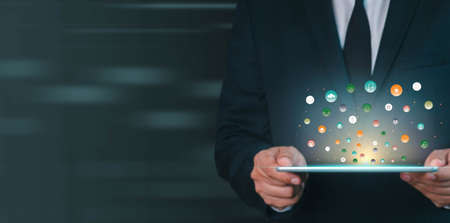 Businessman holding tablet showing virtual icons app. Social digital, Analysis strategy sale...