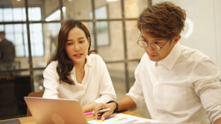 Focus of asian businessman. Corporate business meeting, Office colleagues meeting in office company.Professional business people working briefing, brainstorm, analyze, planning together for success.の写真素材
