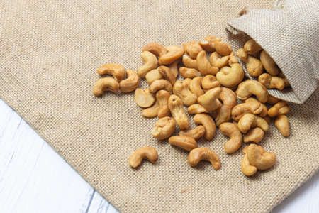 Roasted cashew nut in the burlap bagの写真素材
