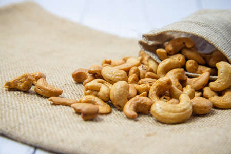 Roasted cashew nut in the burlap bagの写真素材