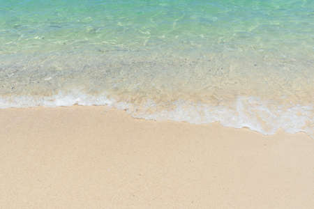 Beautiful clear sand beach and tropical light blue sea. Soft wave of blue ocean on sandy beach. Sallow water, Clear water. Seaside.の写真素材