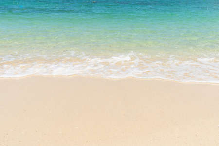 Beautiful clear sand beach and tropical light blue sea. Soft wave of blue ocean on sandy beach. Sallow water, Clear water. Seaside.の写真素材