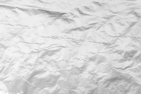 texture closeup of crumpled aluminum foil. Silver aluminum foil texture background. Abstract pattern of metal paper. Texture of crumpled aluminum kitchen foil. Silver abstract backgroundの写真素材
