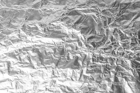 texture closeup of crumpled aluminum foil. Silver aluminum foil texture background. Abstract pattern of metal paper. Texture of crumpled aluminum kitchen foil. Silver abstract backgroundの写真素材