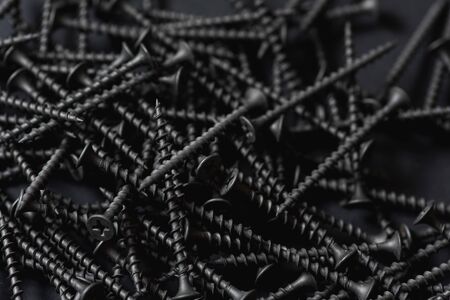 black wood screws on dark backgrounの写真素材