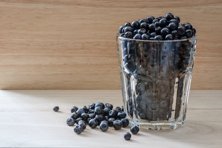 Blueberries in a glass with scattered berries. Vitamin charge for long dayの写真素材
