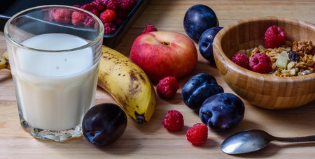 Bowl of muesli with berries,fruits and glass of milk for breakfast. Superfood - very good and healthy breakfastの写真素材