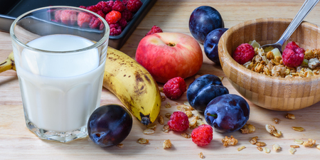 Bowl of muesli with berries,fruits and glass of milk for breakfast. Superfood - very tasty and healthy breakfastの写真素材